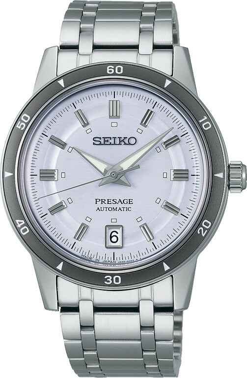 Eine Seiko Presage Automatik Uhr mit hellem, strukturiertem Zifferblatt und einem silbernen Gliederarmband.