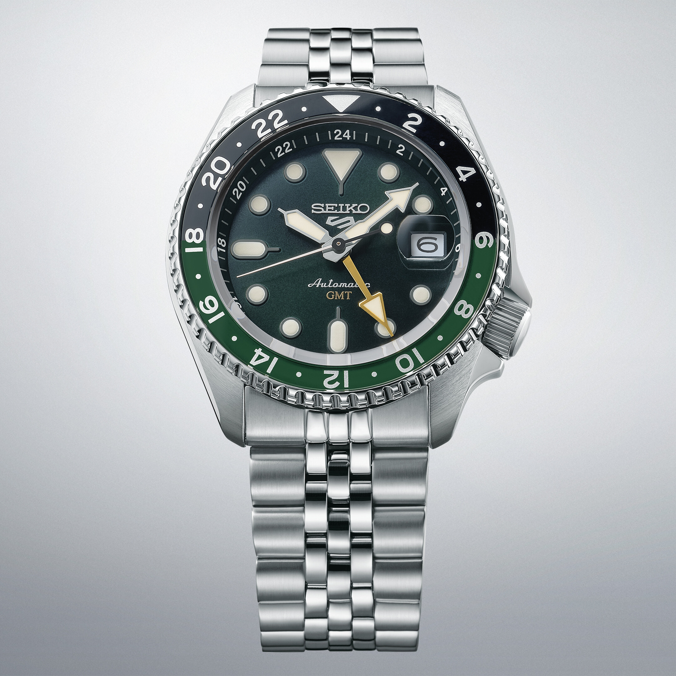 Eine elegante Armbanduhr mit einem dunkelgrünen Zifferblatt und einer zweifarbigen Lünette in Schwarz und Grün.